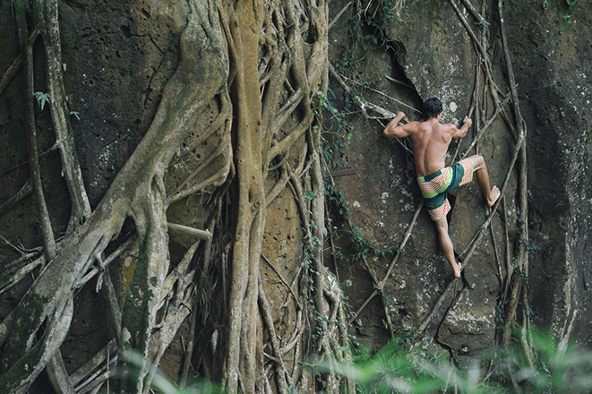 Rockclimber scaling a waterfall